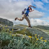 Bushwalker striding across an alpine ridge in the Snowy Mountains