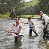 Guests learning to fly fish in the river near Elm Cottage, Tumut
